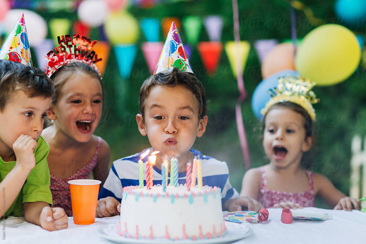 Child blowing birthday candles