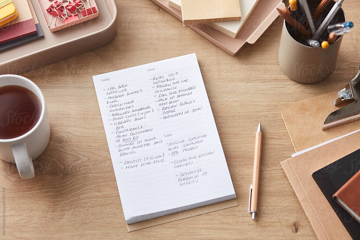 Composed notepad with mug and office supplies
