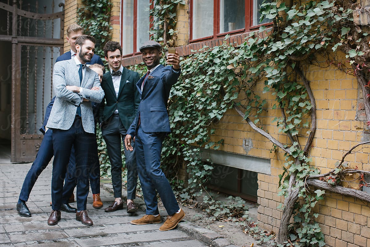 Five Stylishly Dressed Young Men Taking Selfie Outdoors