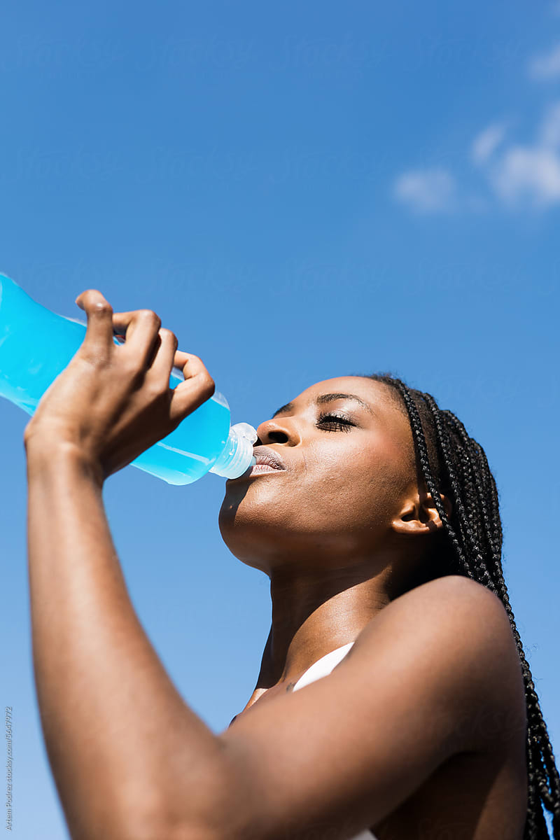 Hydration Break: Young Woman Quenching Thirst