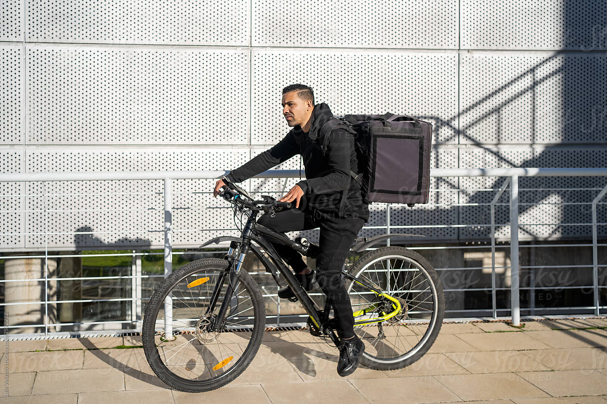 Hispanic Courier With Bicycle Delivering Food.