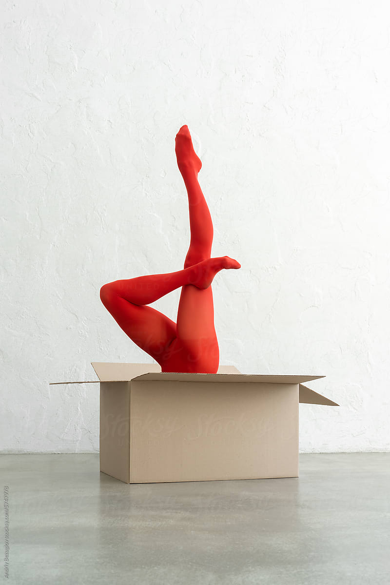 Performance of athletic woman in bright red tights with craft bo