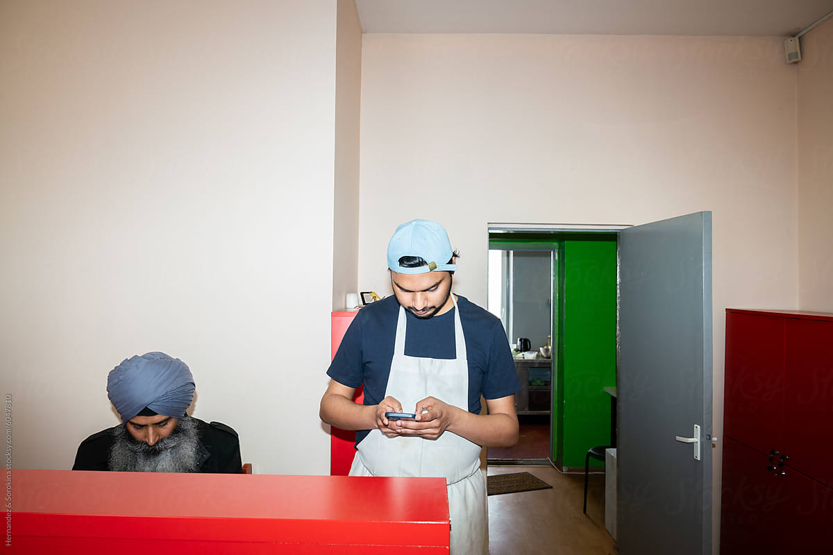 Indian Restaurant Owner And Cook Working At Reception