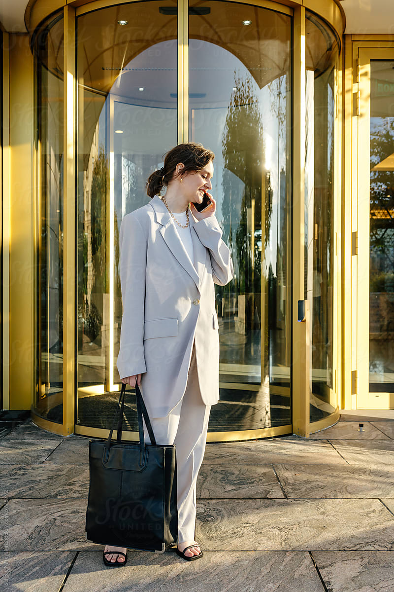 Businesswoman phone call near revolving doors