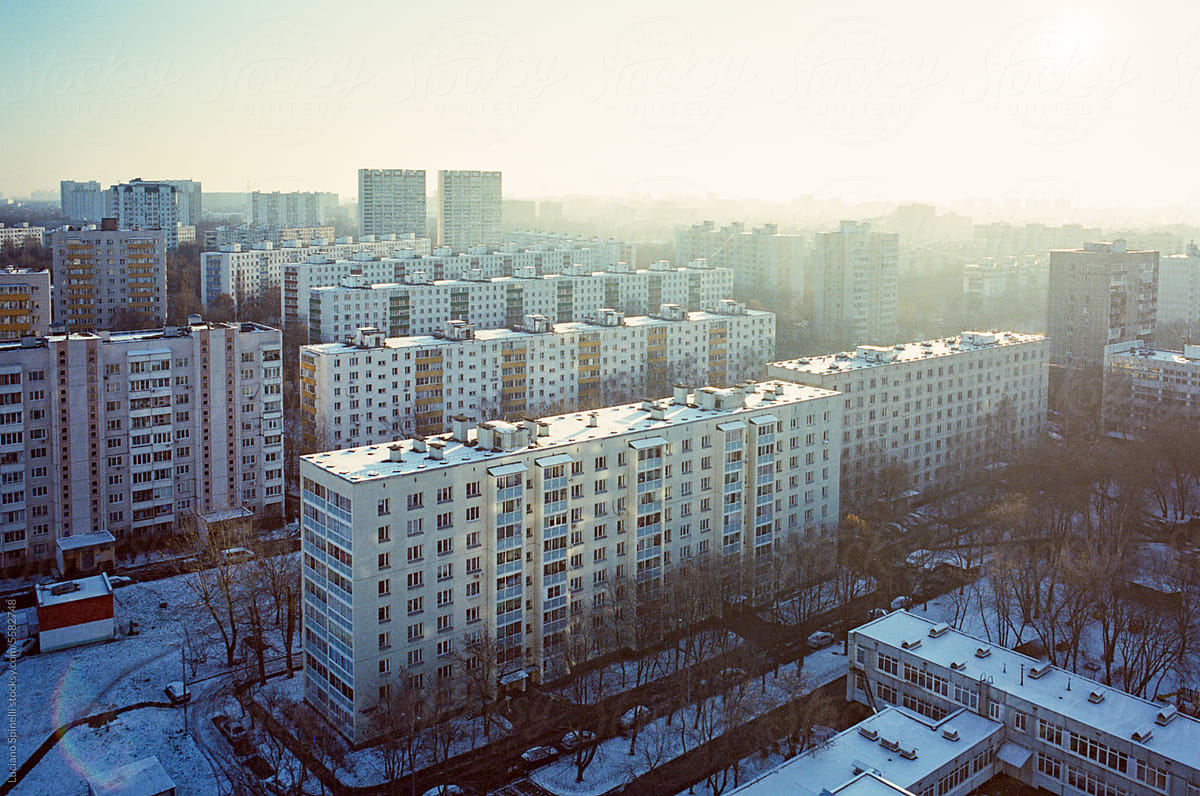 Sunny winter day: sunlight over cityscape with snow on the streets