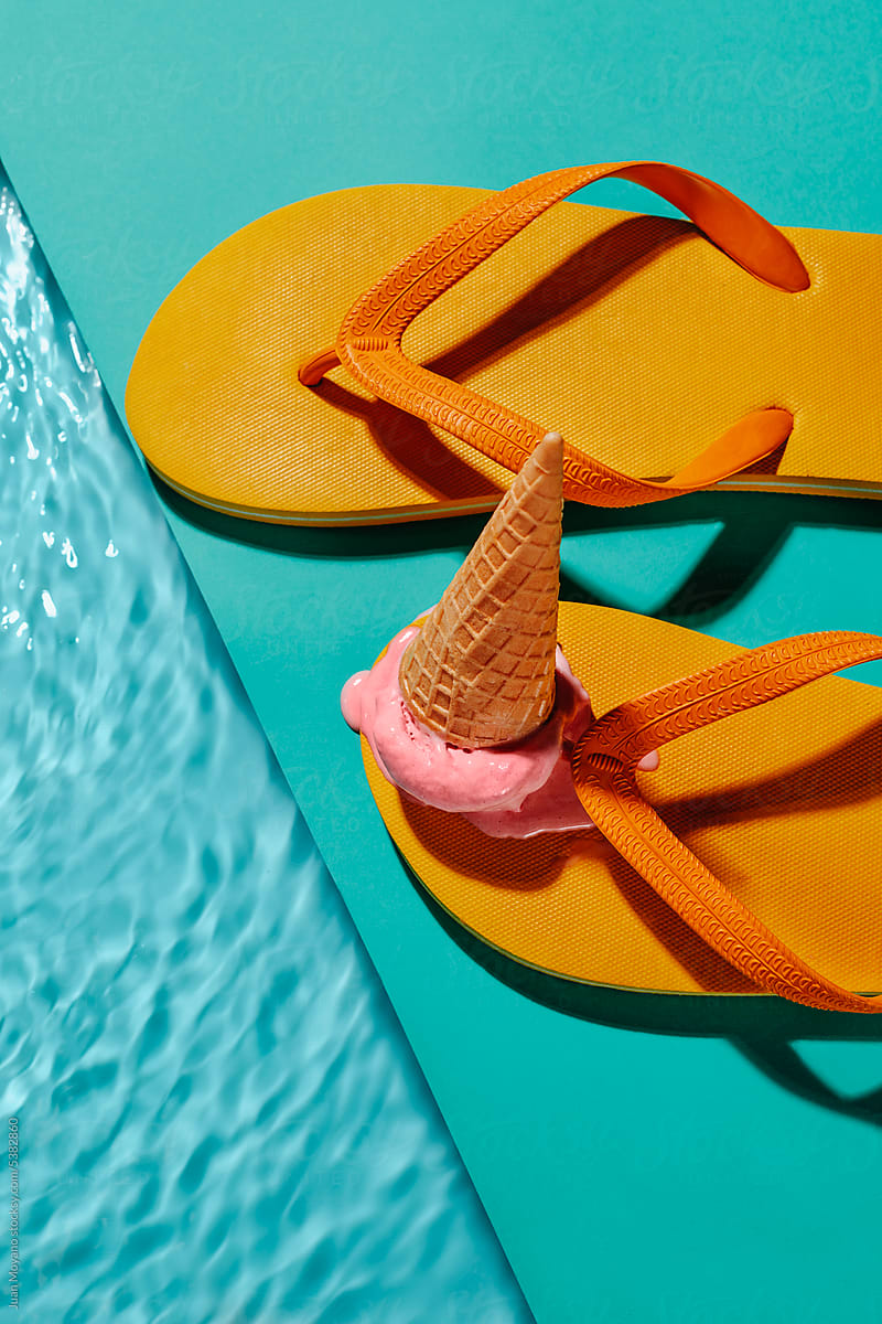 ice cream cone dropped on a pair of yellow flip-flops