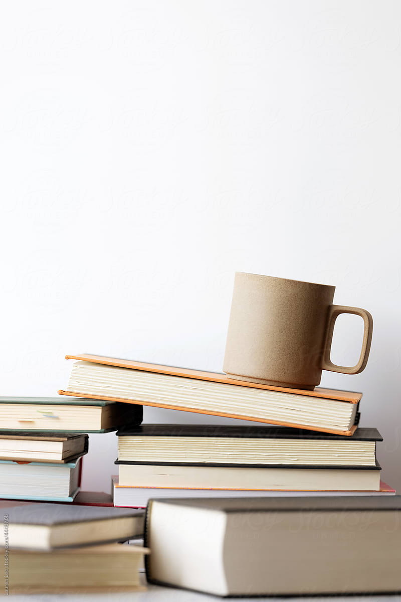 Coffee mug resting on stack of books