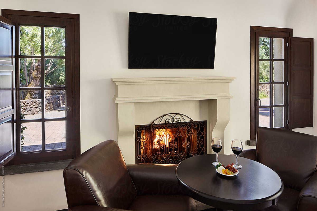 Luxury hotel room with red wine and fireplace at boutique hotel