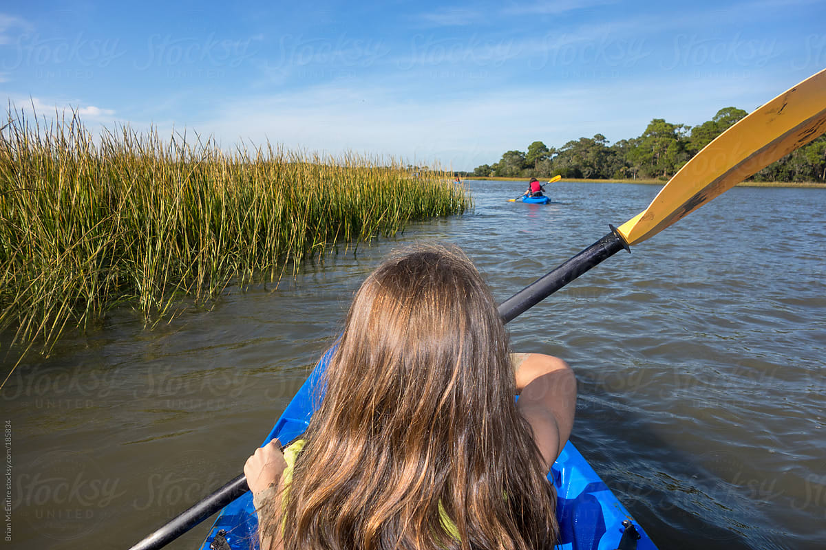 Little Girl Kayaking with Family in Distance on Salt Marsh Tour of Carolina Low Country
