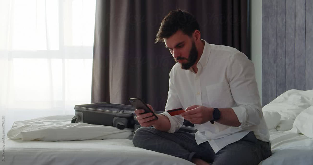 Man Sitting In Hotel Room In His Underwear by Stocksy Contributor