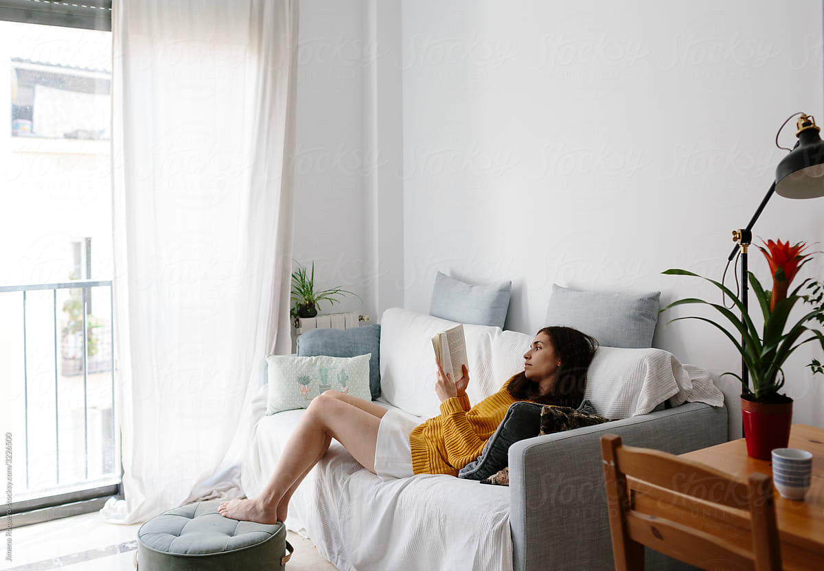 Young woman at home reading