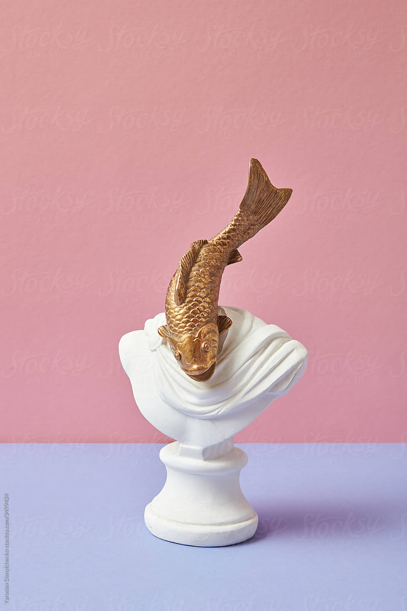 Plaster statue with head in the shape of goldfish.
