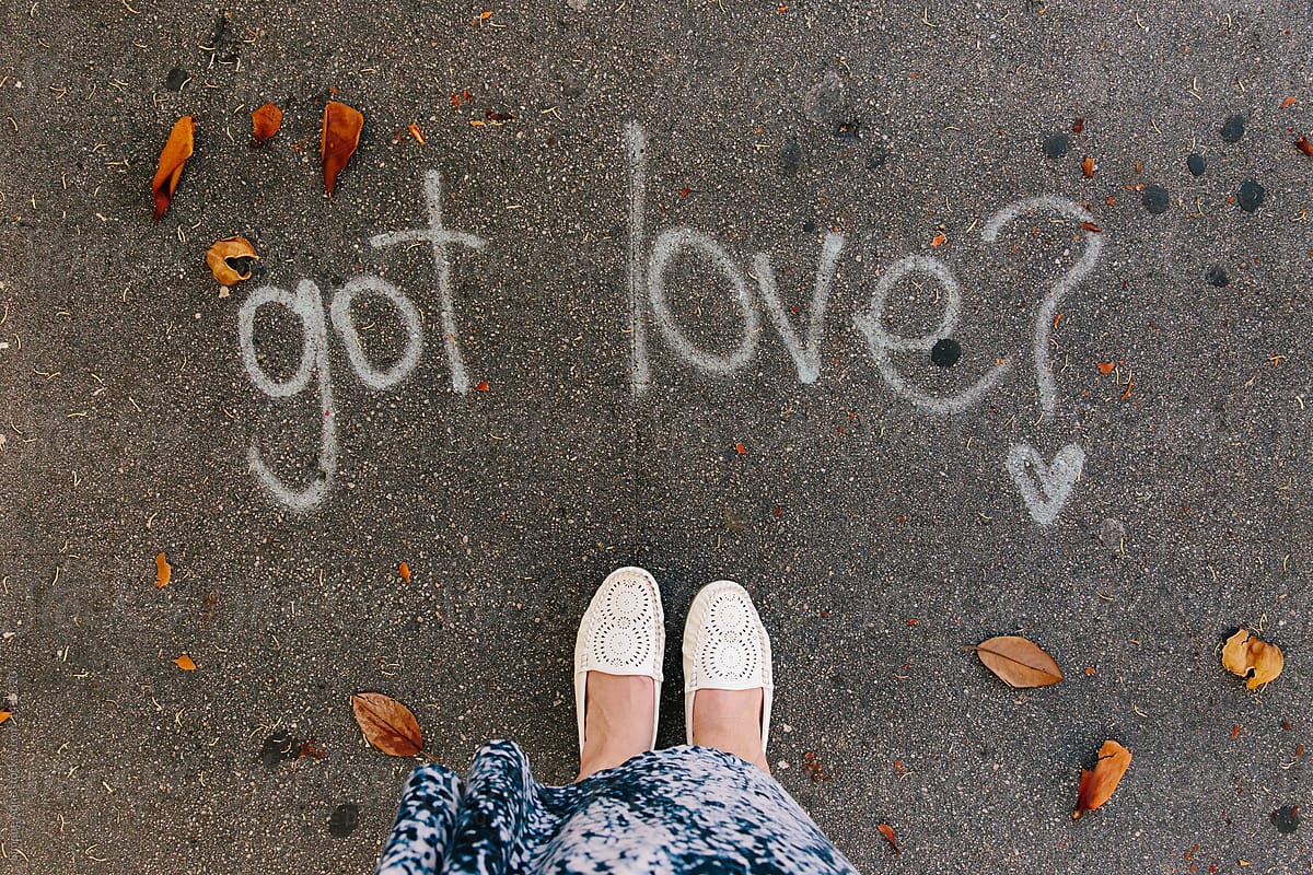 Got Love? graffiti on the floor with white shoes and blue and white skirt