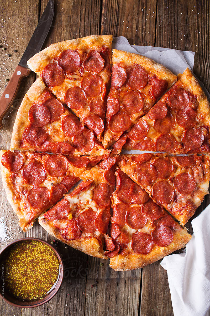 Pizza salami on wooden background. Cheese And Pepperoni Pizza
