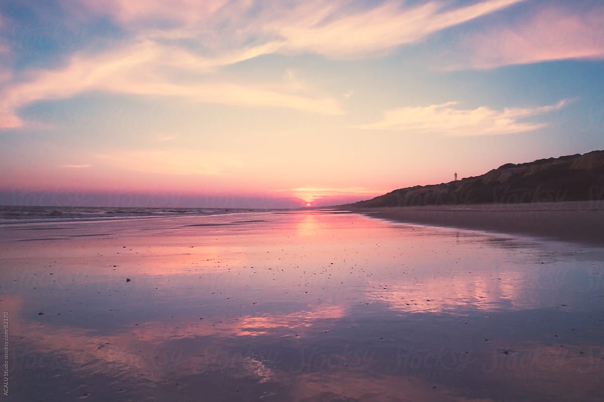 Beach with pink sky at sunset