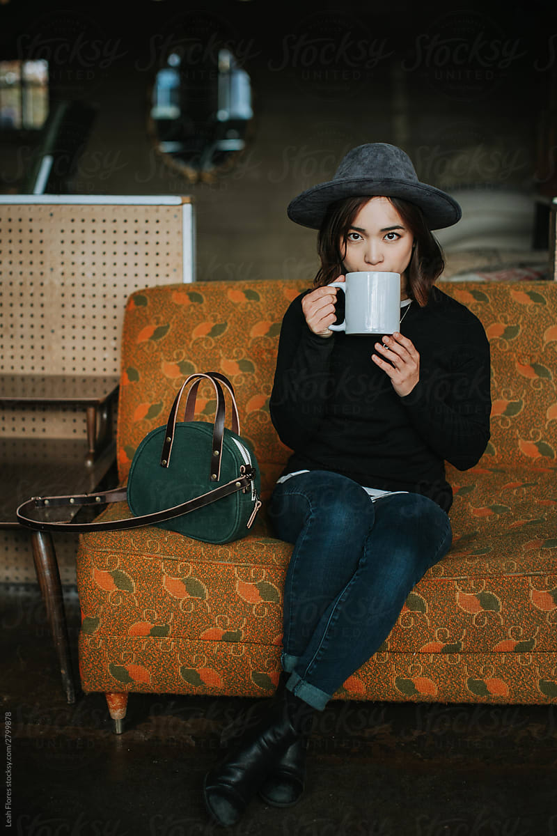 Woman Drinking Coffee at Retro Coffee Shop
