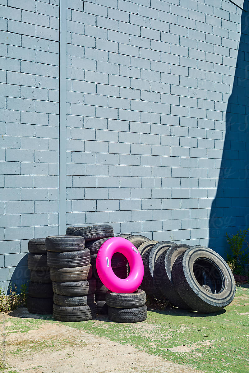 pink swim ring on a pile of old tires