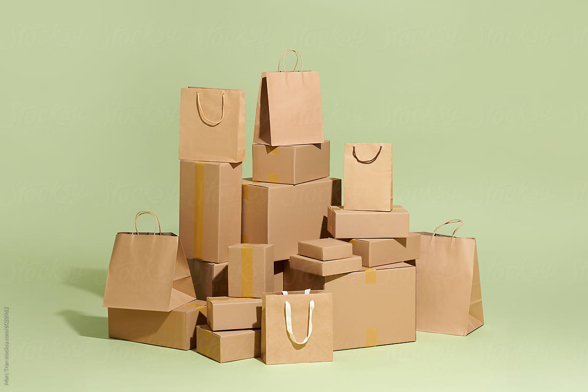 Kraft packaging, boxes, and packages on a green background. Delivery.
