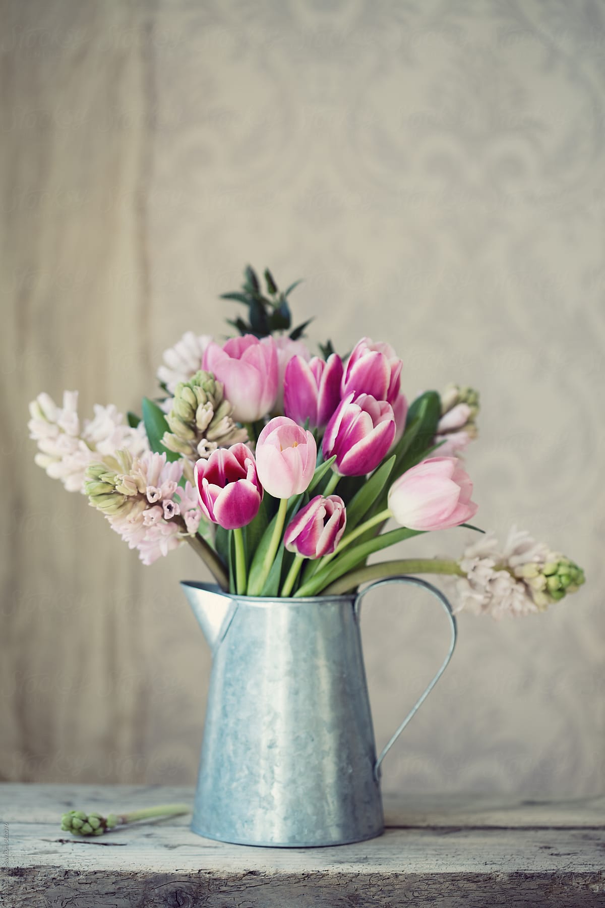 Spring flowers in a tin jug