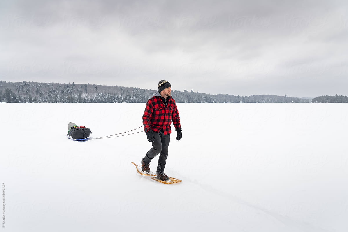 Snowshoeing Trek with Winter Camping Pulk on Frozen Lake