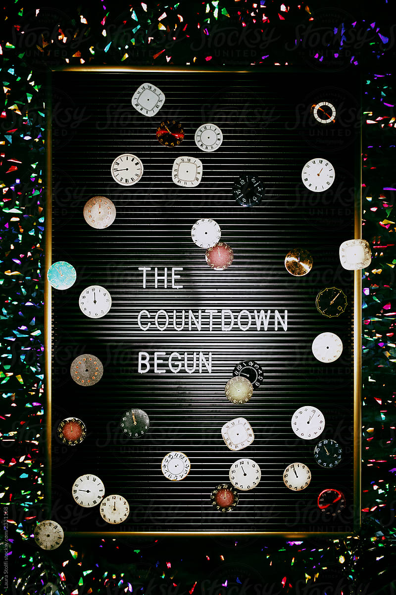 Many elegant clocks on top of letter board spelling The countdown begun