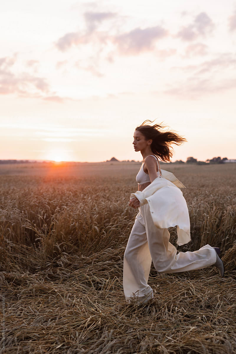 Woman in loungewear running during sundown