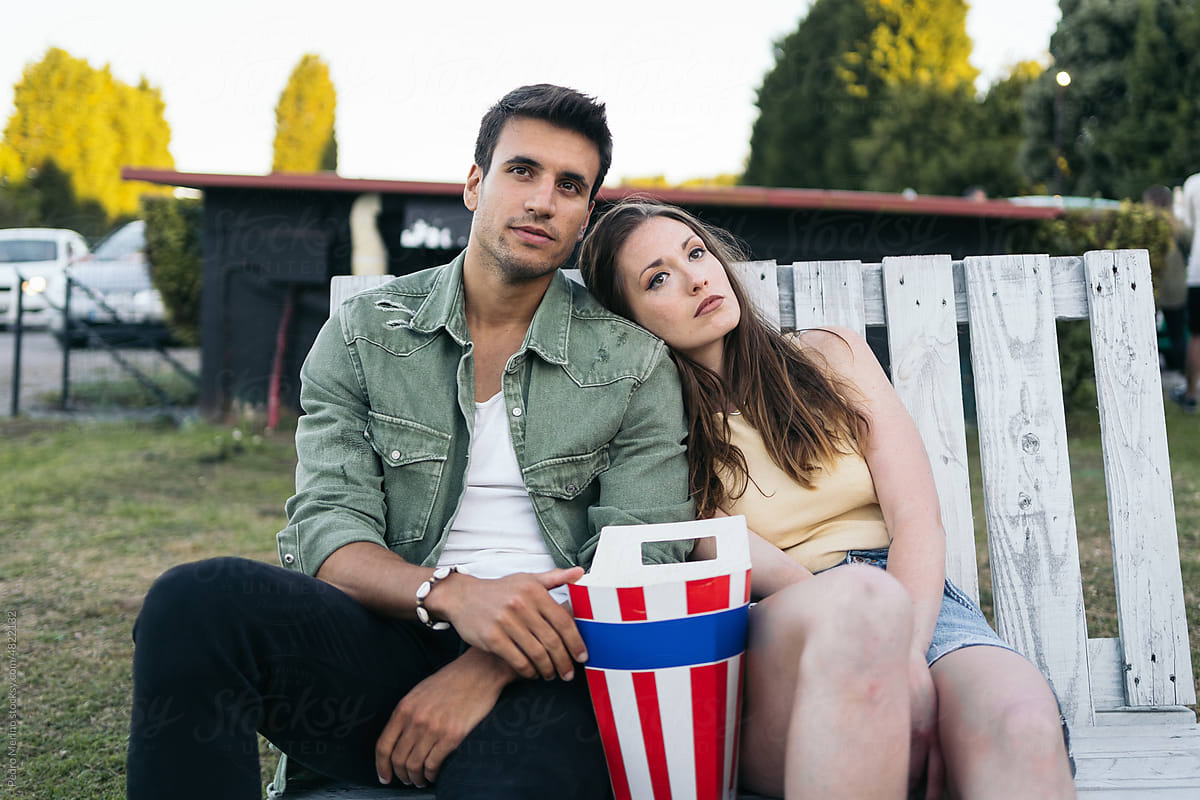 Couple watching a movie in a summer outdoor cinema