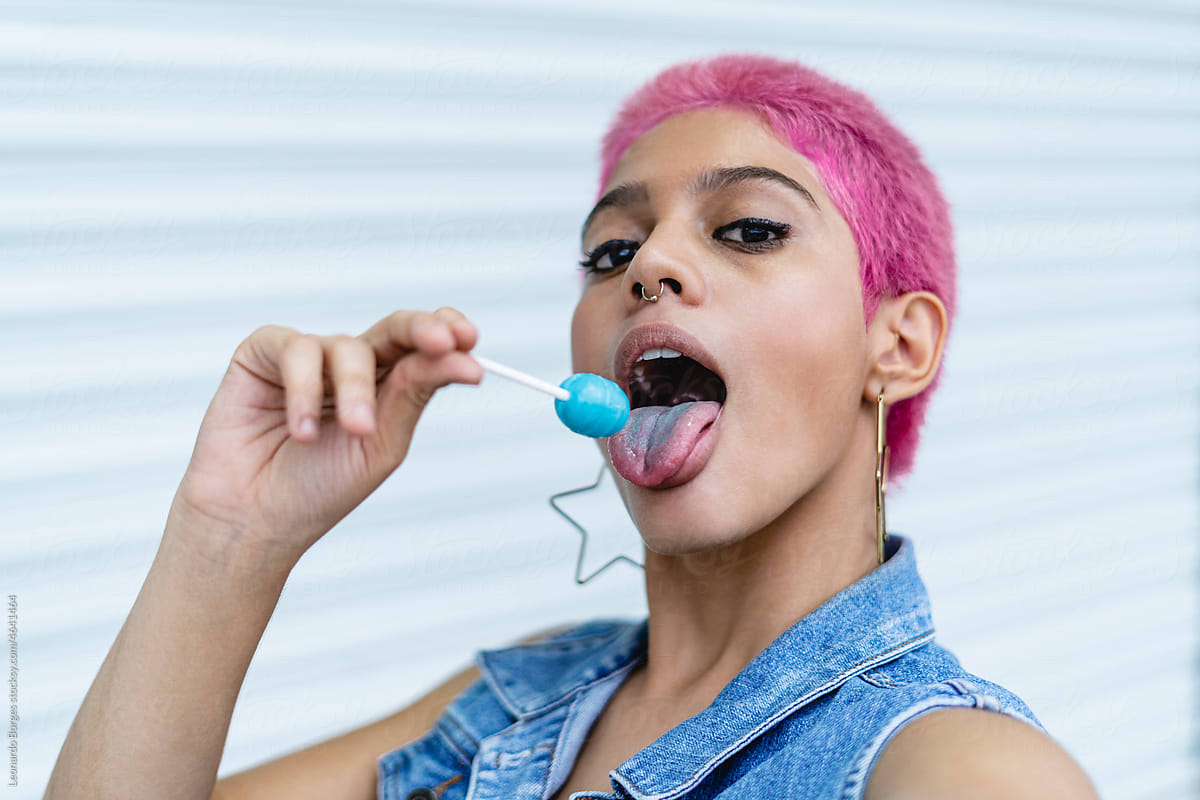 portrait of a woman eating a candy