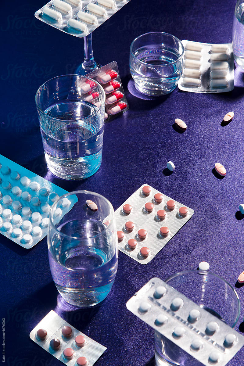 Medicine tablets and glass with water