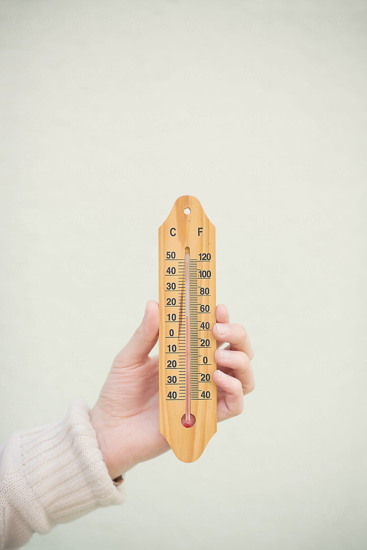 Hand Holding A Thermometer Outside by Stocksy Contributor B & J - Stocksy