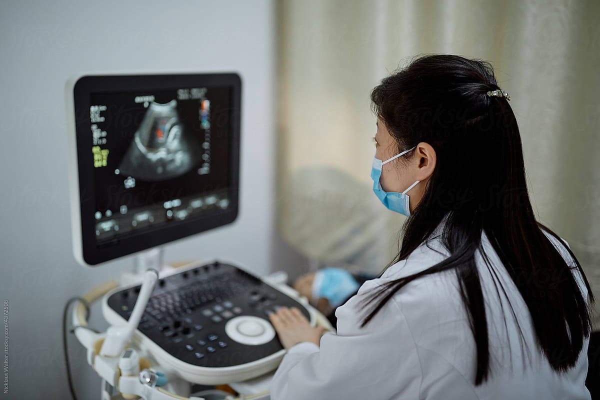 Female Chinese obstetrician performs an ultrasound