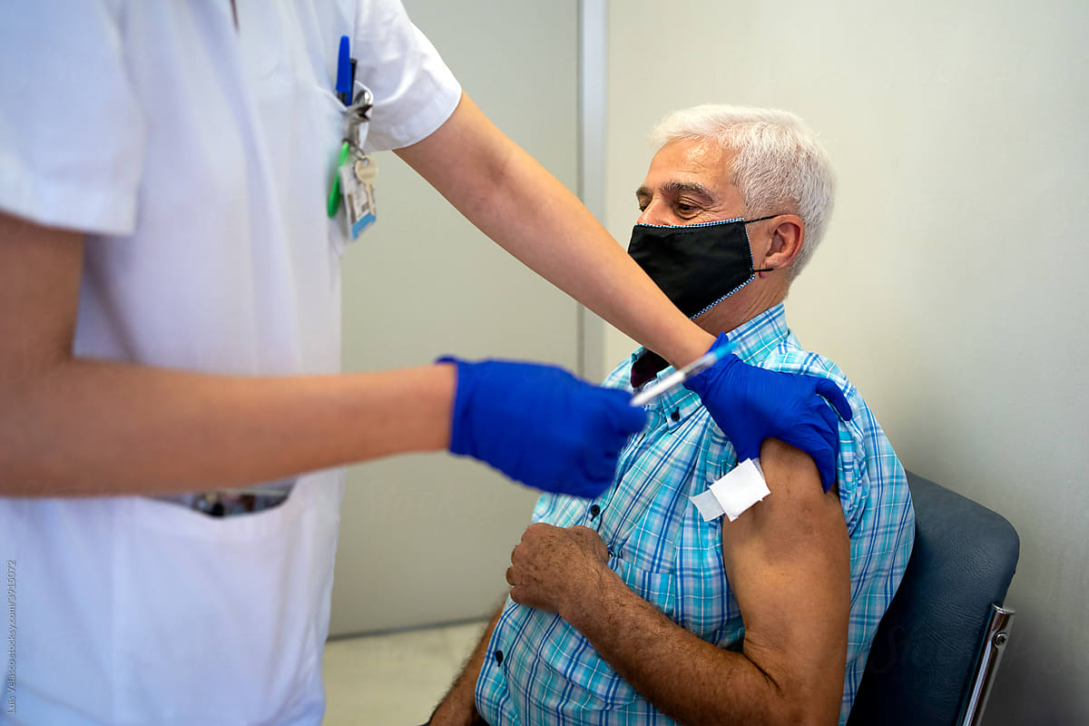 Old Man Receives COVID-19 Vaccination In The Hospital.