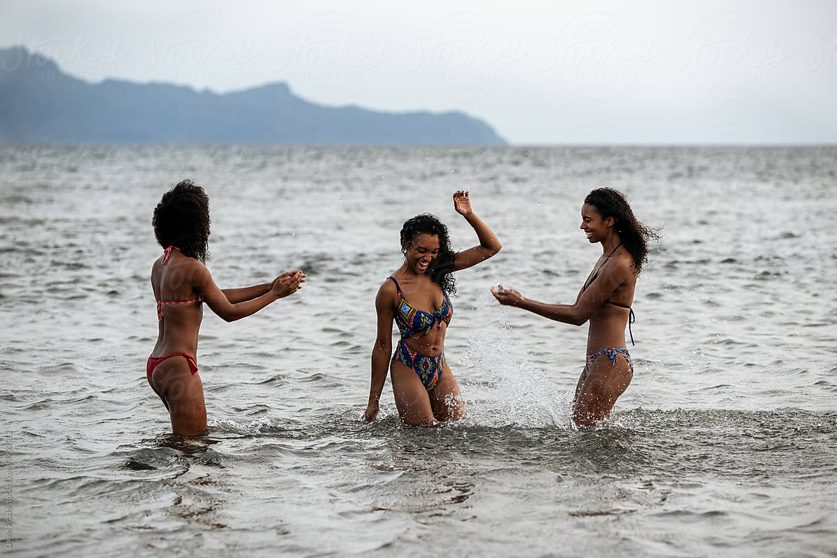 Women Sisters In Bikini In A Volcanic Beach" Contributor "David Prado" - Stocksy