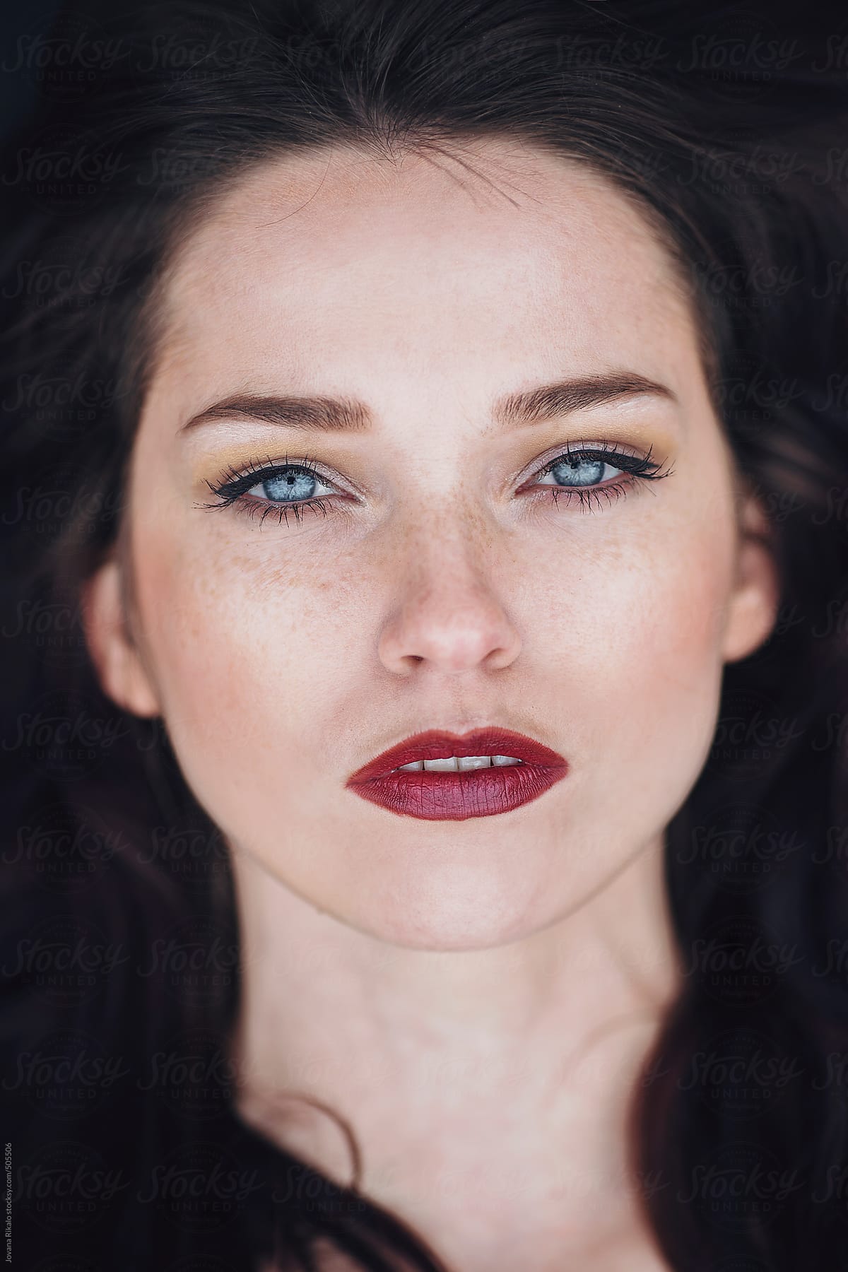 Portrait Of A Beautiful Young Woman With Freckles And Blue Eyes Del Colaborador De Stocksy 