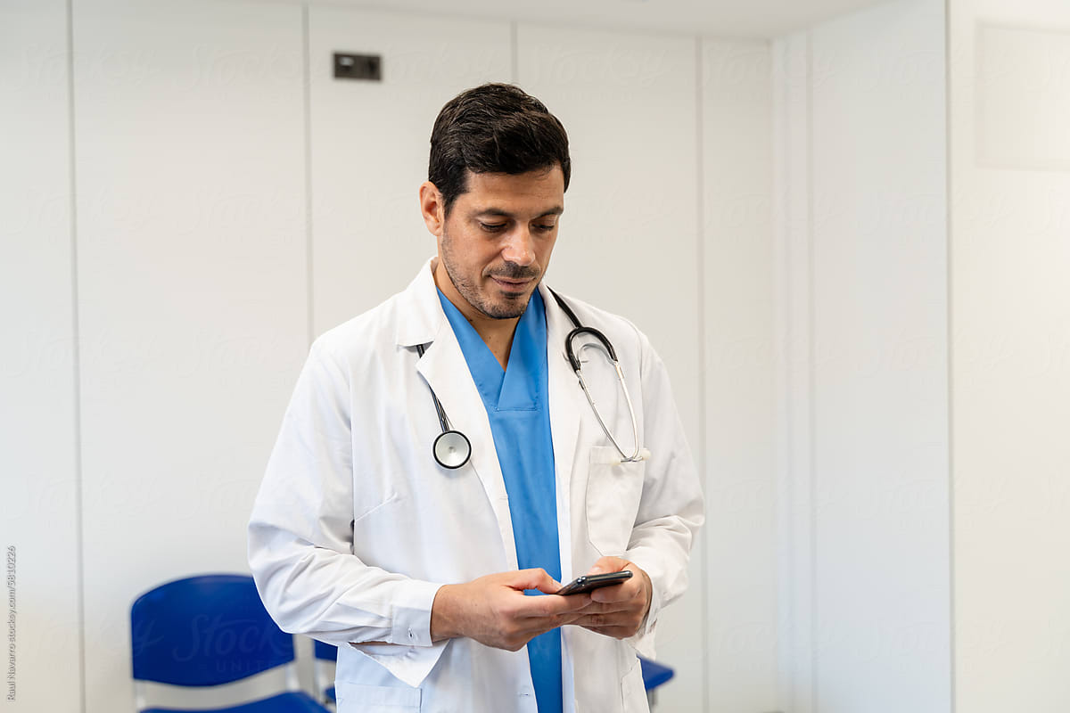 Portrait of a male doctor using mobile phone