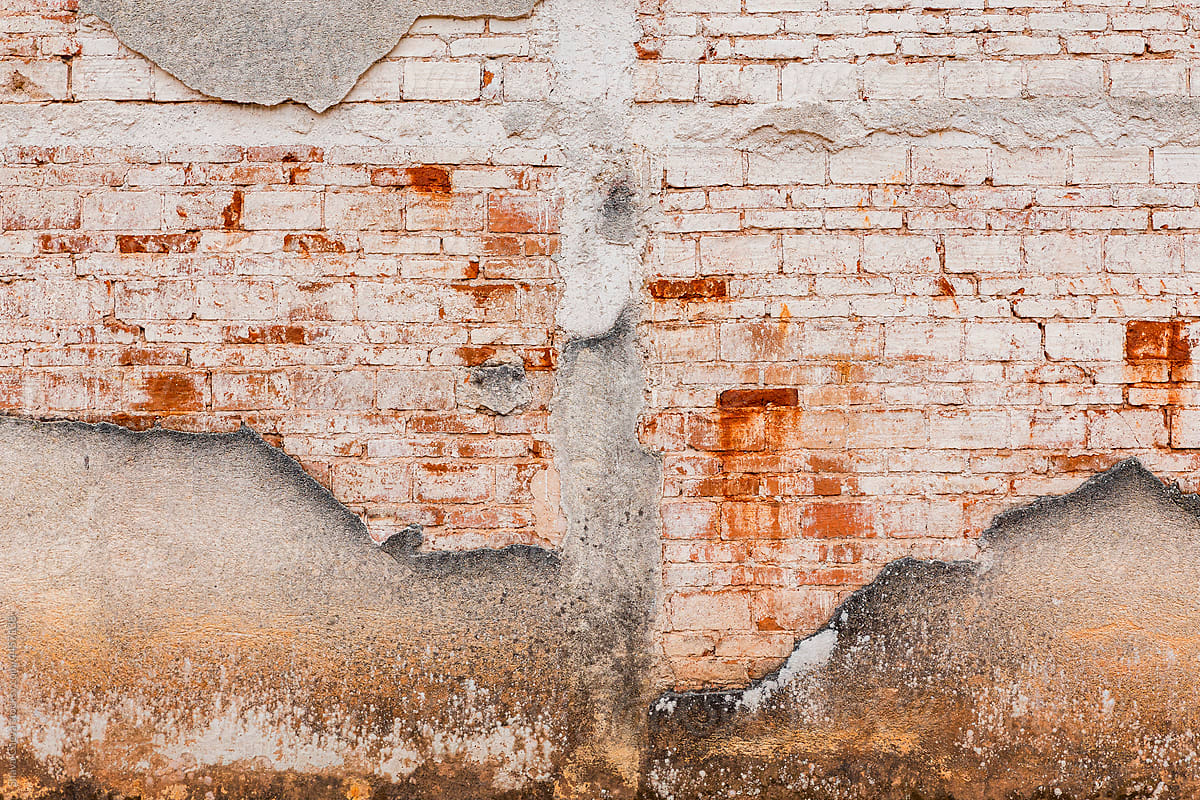 Weathered red brick wall in an abandoned house