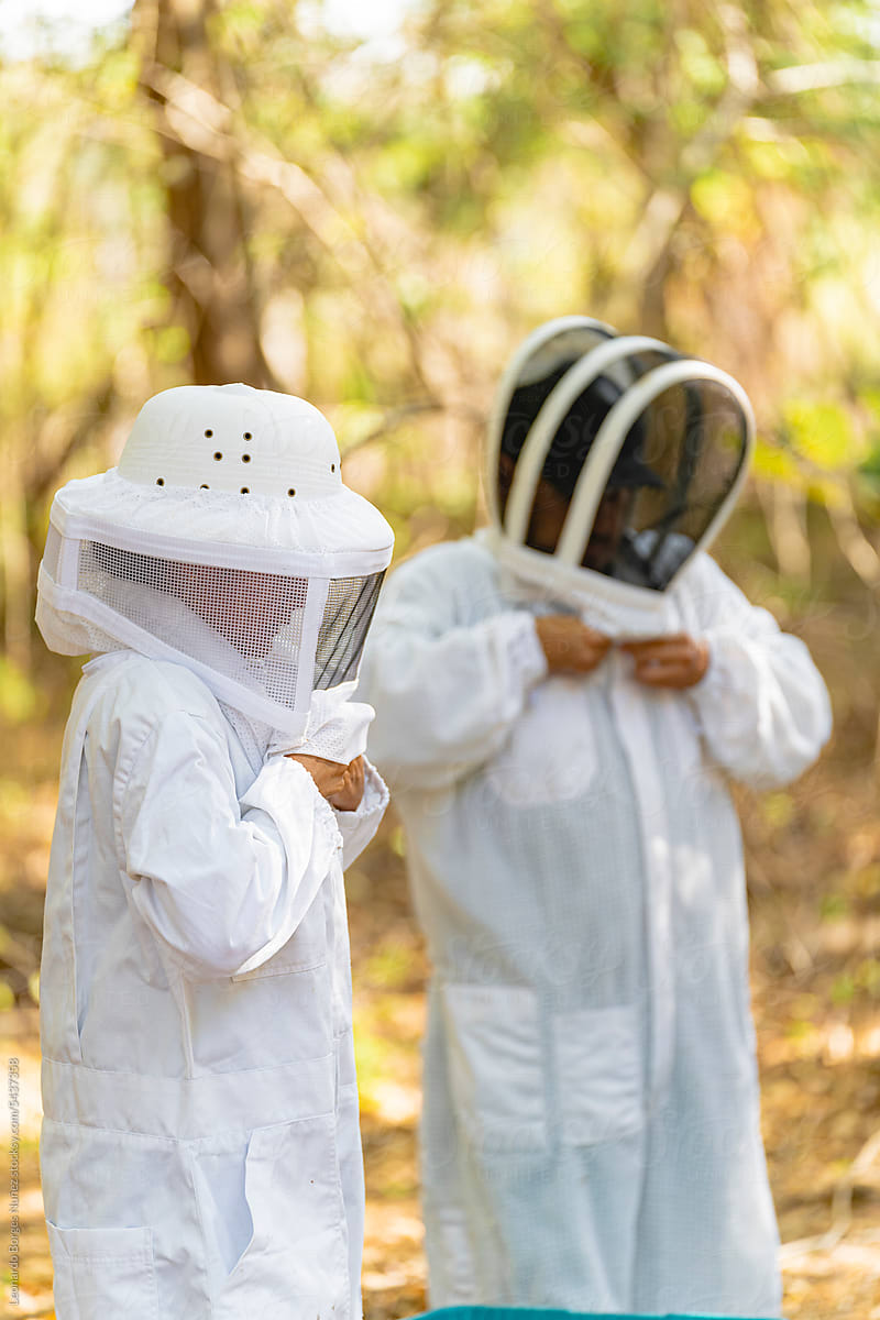 Beekeepers putting on their protective gear.