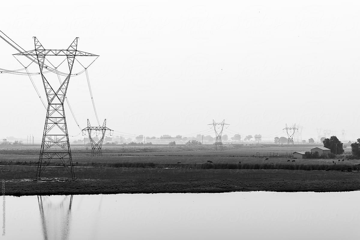 Transmission towers in a smoky rural setting