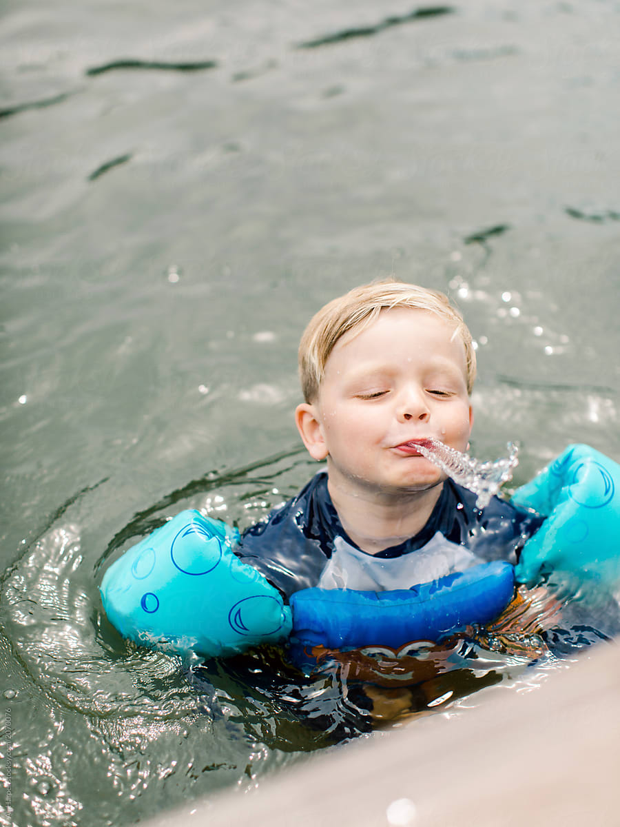 Little boy playing in lake