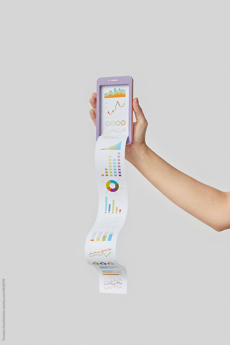 Smartphone with paper statistics in hand.