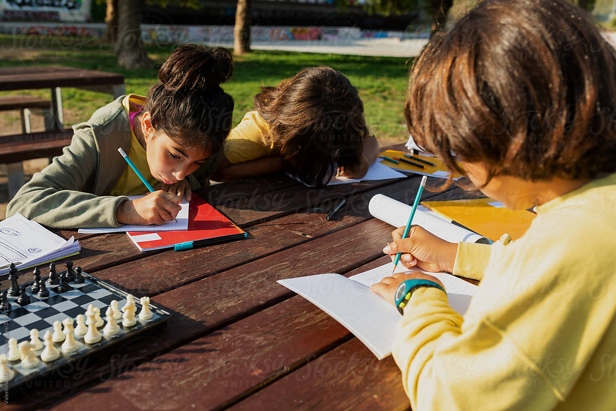 children doing homework outdoor