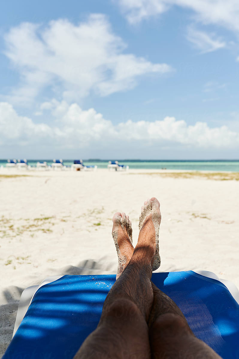 Man sitting on a sandy beach