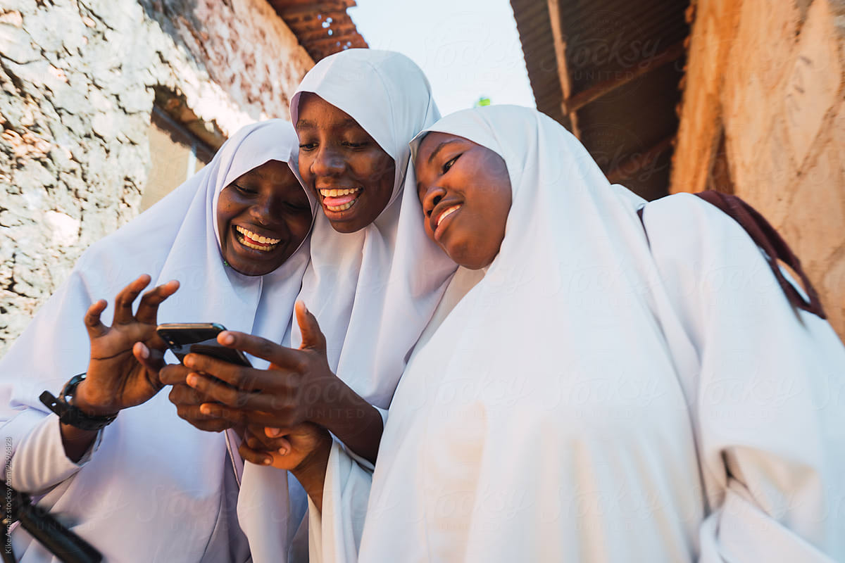Group of zanzibari students using mobile phone