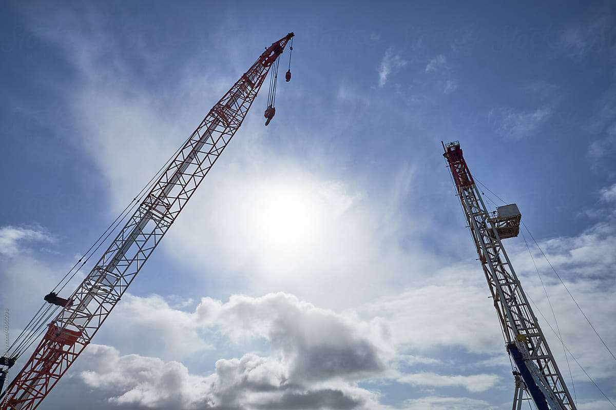 Large crane masts against a blue sky