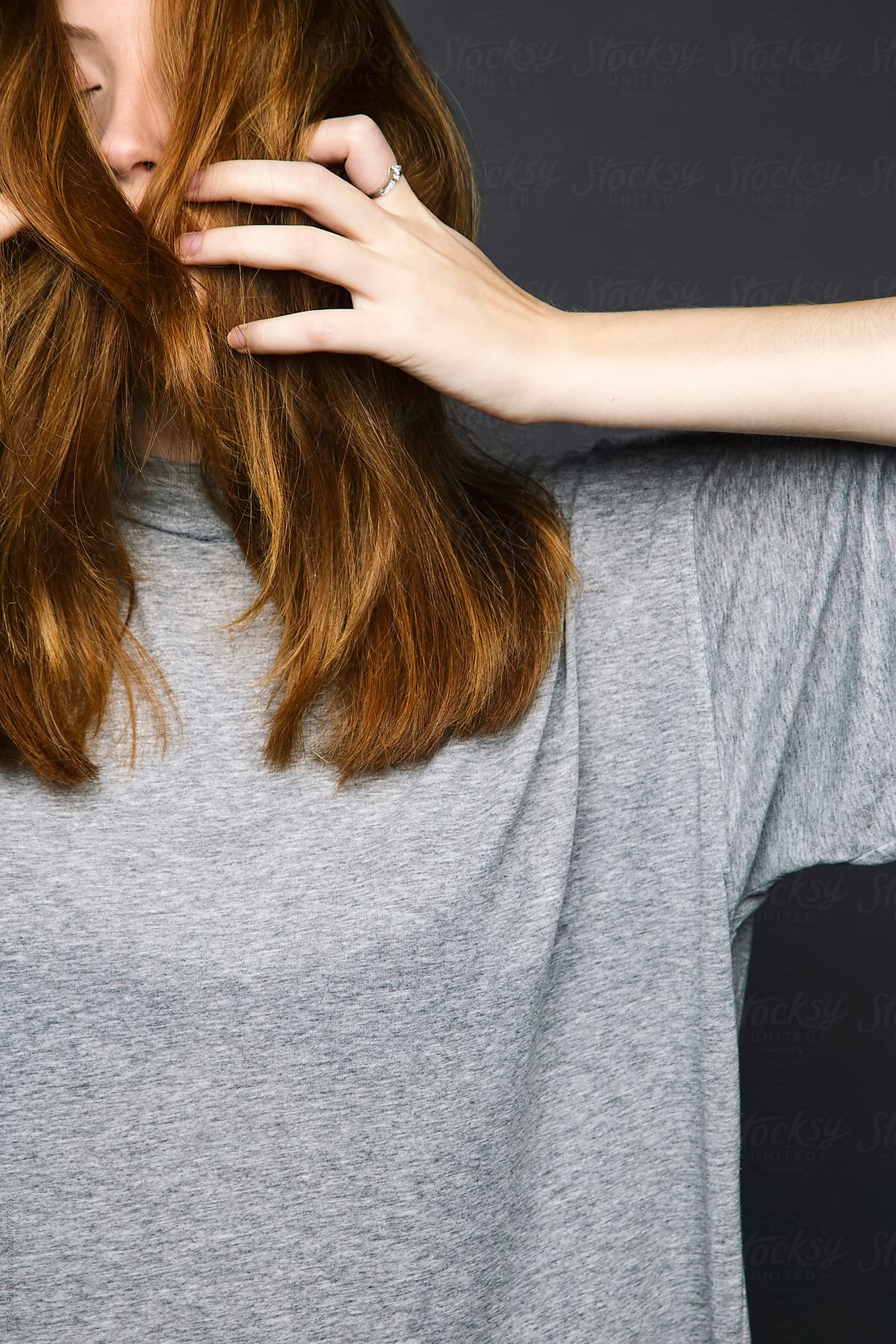 Young Redheaded Woman Hiding Her Face Behind Her Hair Del Colaborador De Stocksy Danil Nevsky
