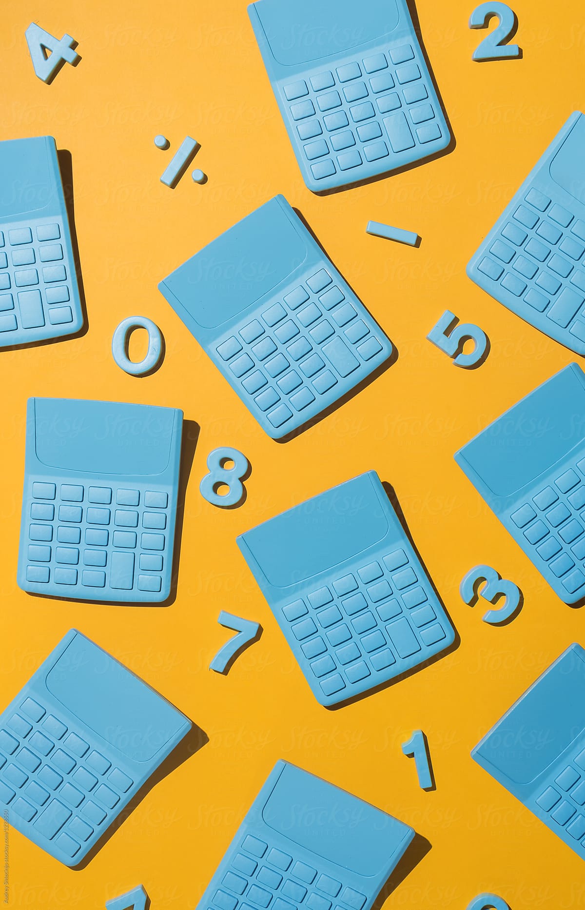Blue pocket calculators with numbers on orange background.