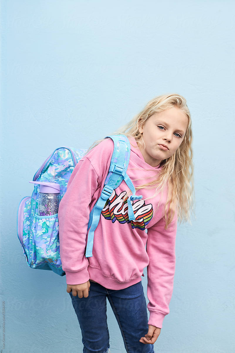 Blonde girl with heavy school bag