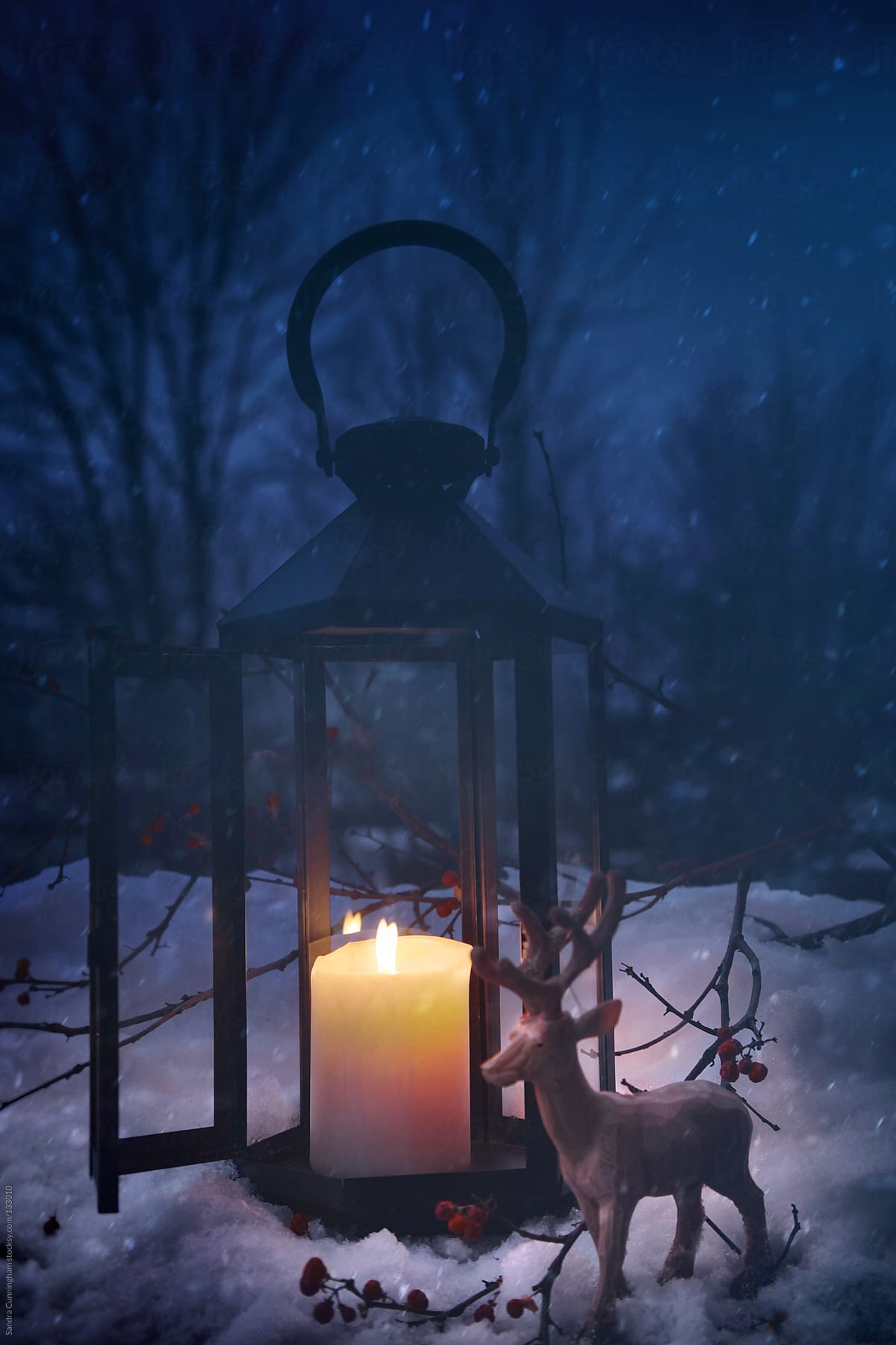 Lit lantern in the snow on a snowy night
