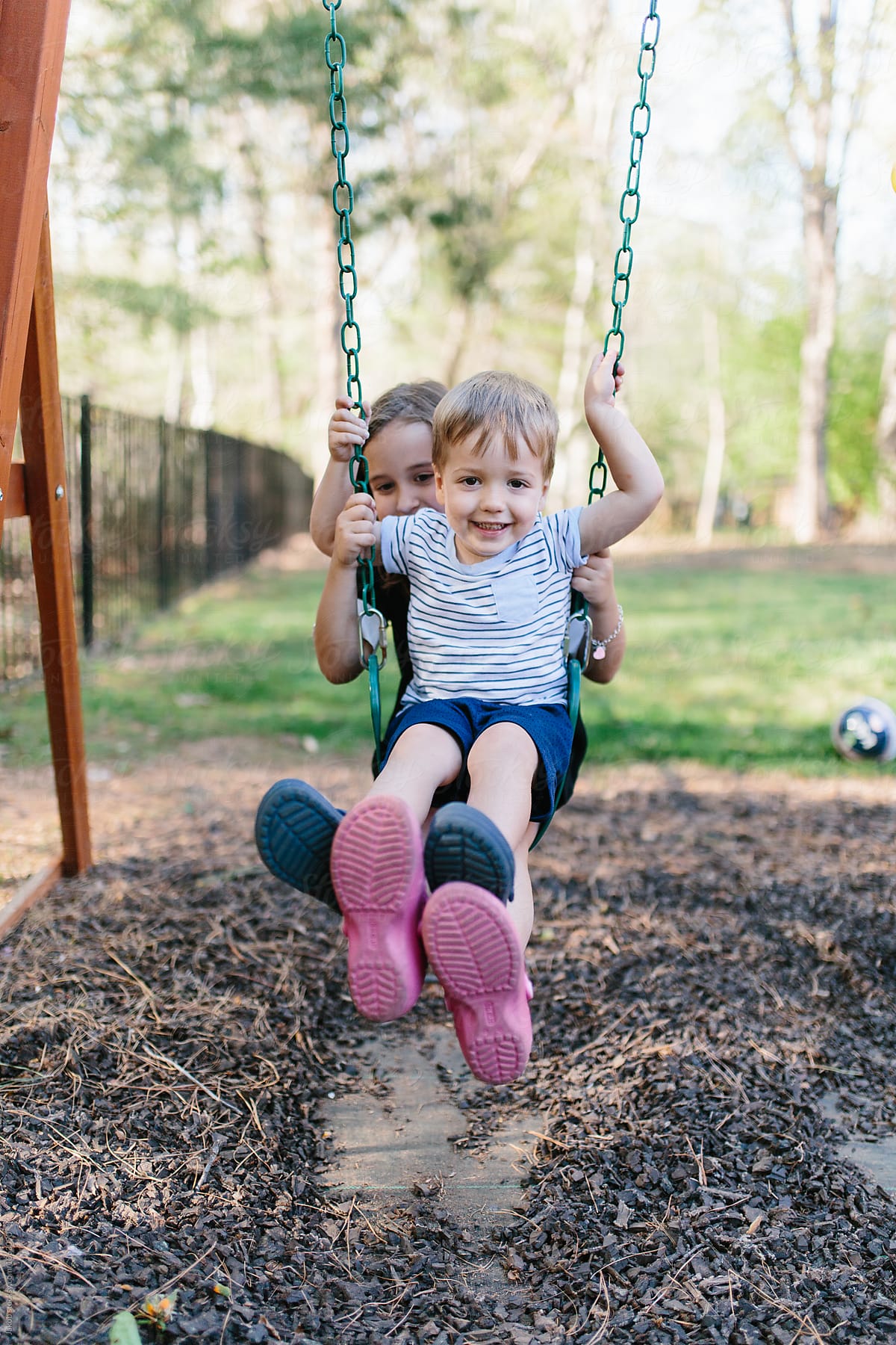 Brother And Sister Sitting On A Swing Together By Stocksy Contributor Jakob Lagerstedt Stocksy 
