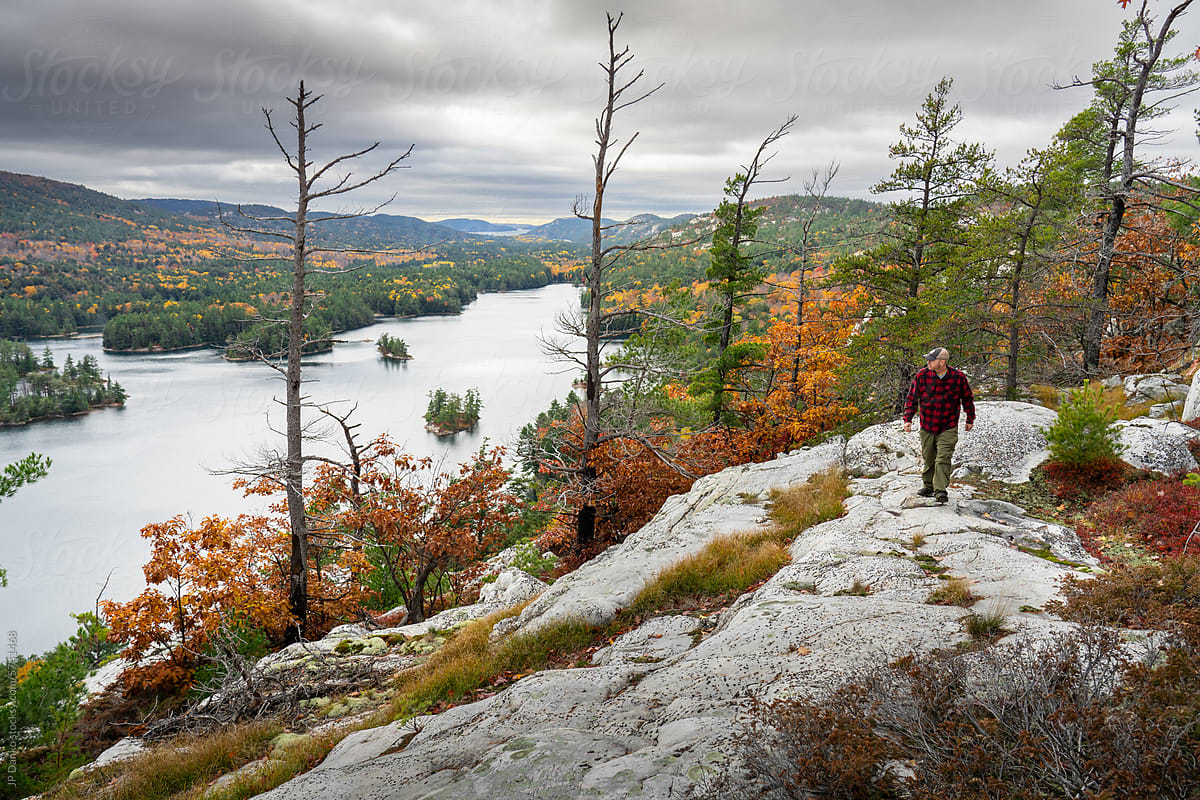 Man Hiking Along Mountain Ridge in Autumn